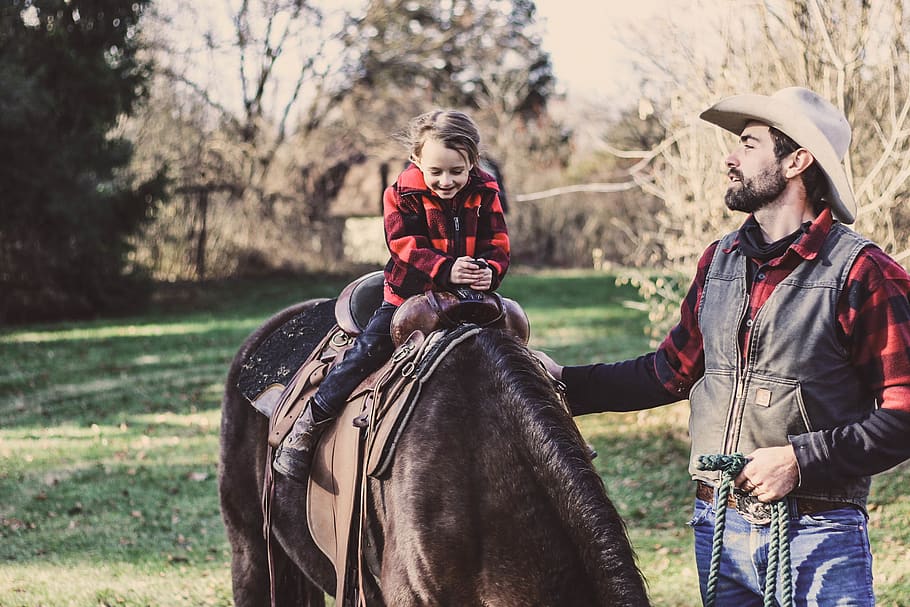 Little Girl Riding Horse Beside Man, adorable, adult, child, cowboy