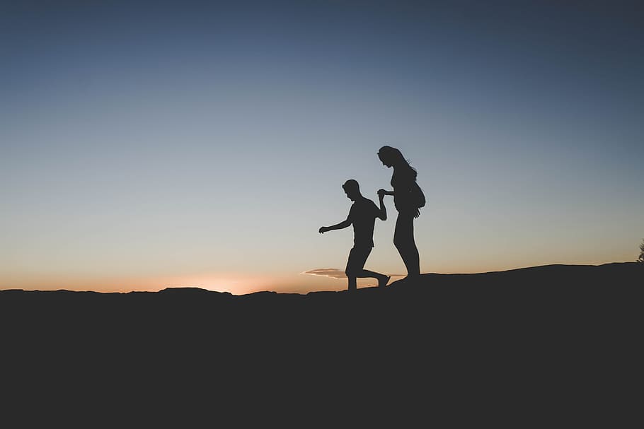 silhouette of man and woman walking on mountain, nature, sunset