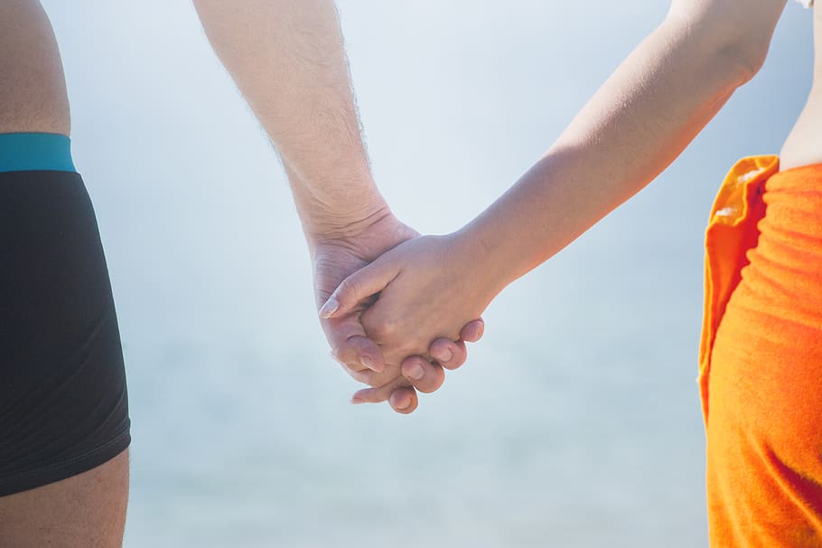 Midsection of Couple Holding Hands at Beach Against Sky, bonding HD wallpaper