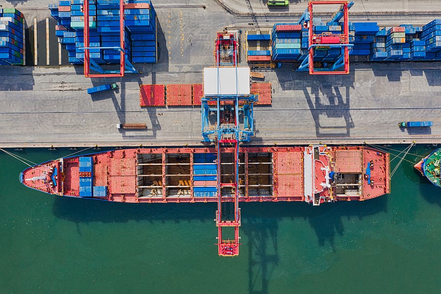 Aerial Photo of Cargo Ship Near Intermodal Containers, aerial shot