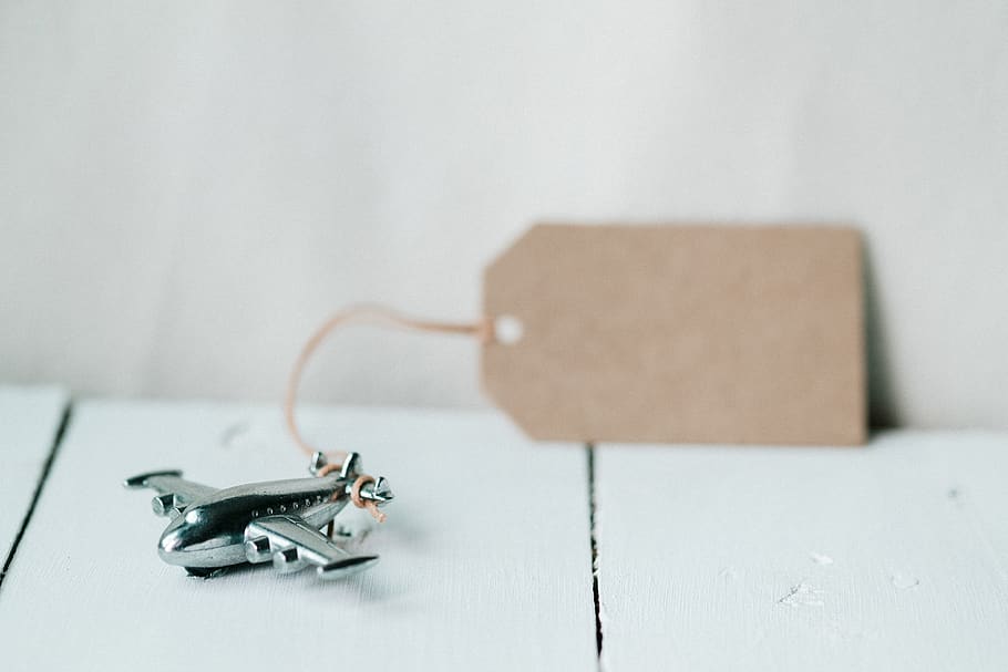desk, tag, airplane, silver, toy, blur, indoors, no people HD wallpaper
