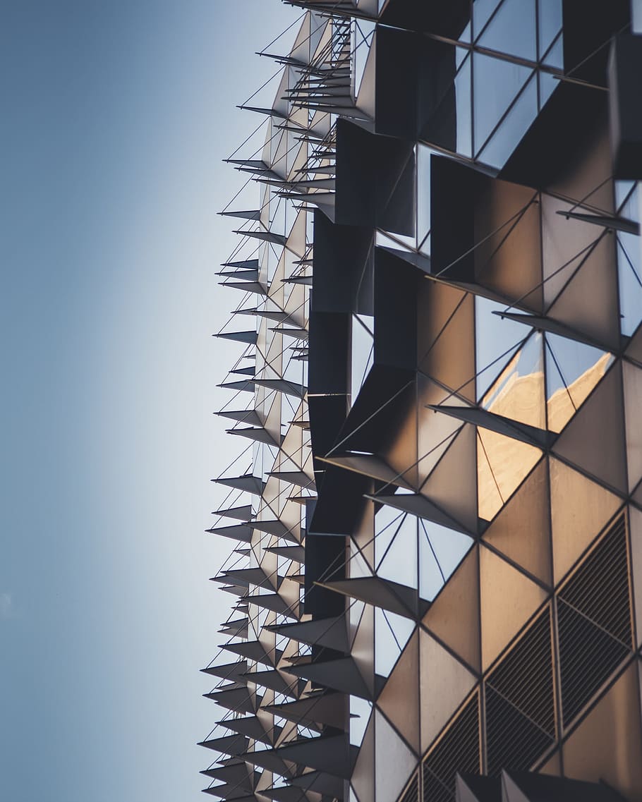 low-angle photography of brown and clear building during daytime HD wallpaper
