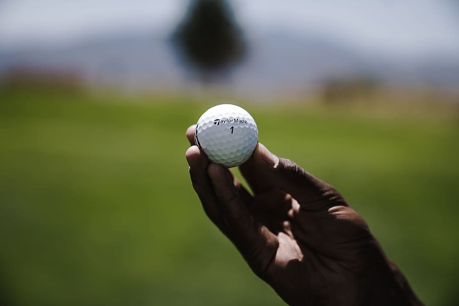 Selective Focus Photography of Person Holding Golf Ball, blurred background HD wallpaper