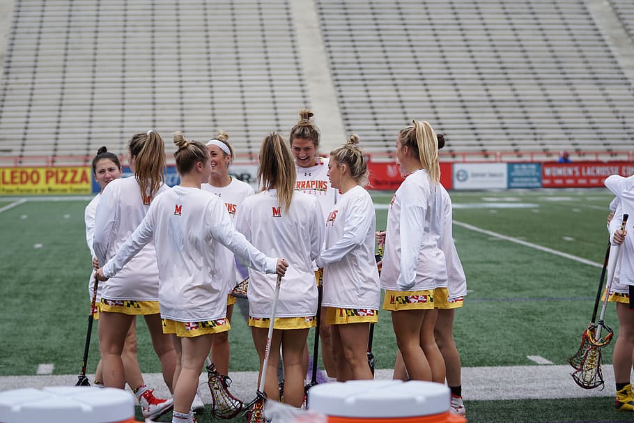 group of women playing lacrosse, person, human, apparel, shorts