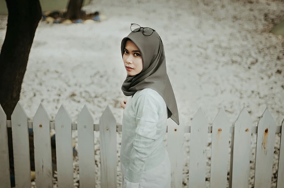 woman wearing gray hijab standing beside white fence, picket, HD wallpaper