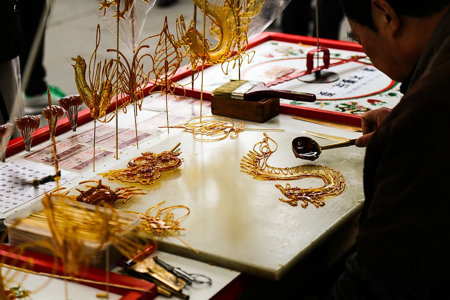 man doing dragon art on table, indoors, art and craft, one person HD wallpaper