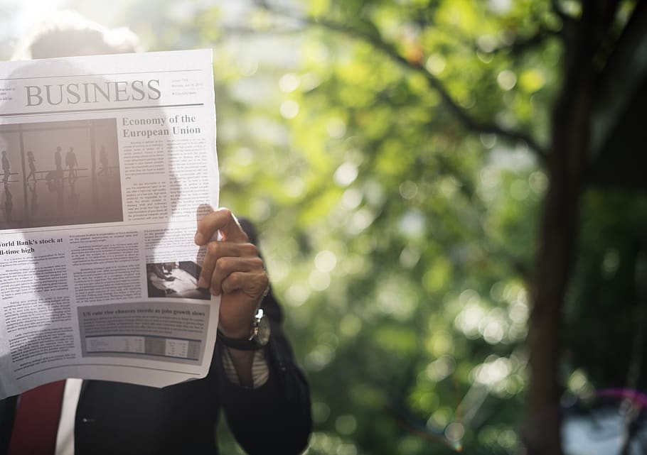 Person Holding Newspaper Near Trees, blur, blurry, bright, close-up HD wallpaper