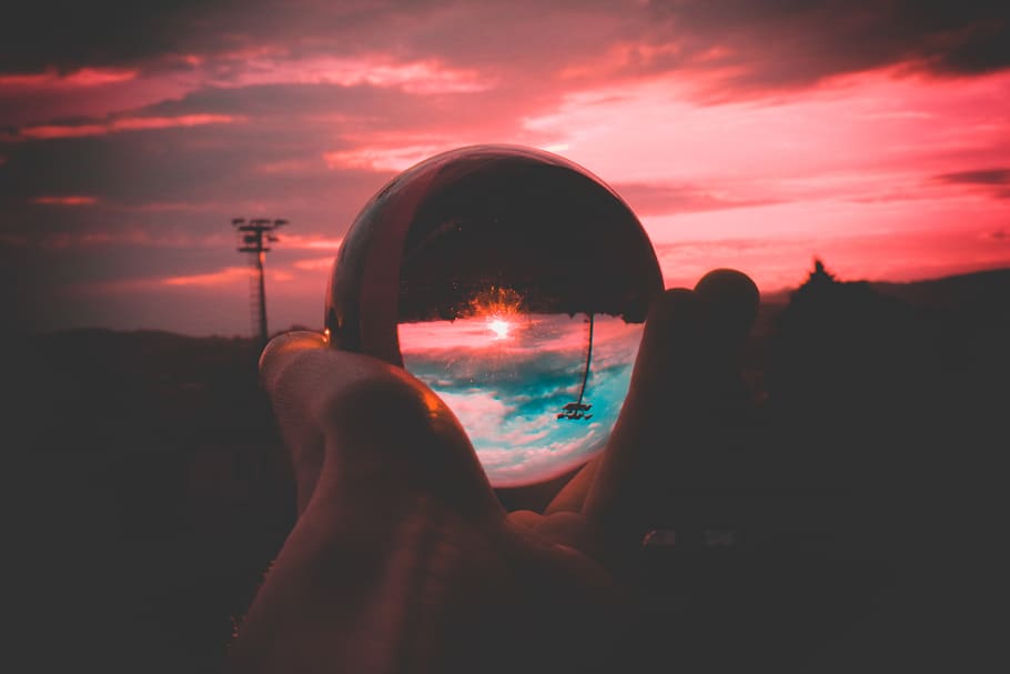 Person Holding Round Clear Glass Decor, backlit, clouds, crystal ball HD wallpaper