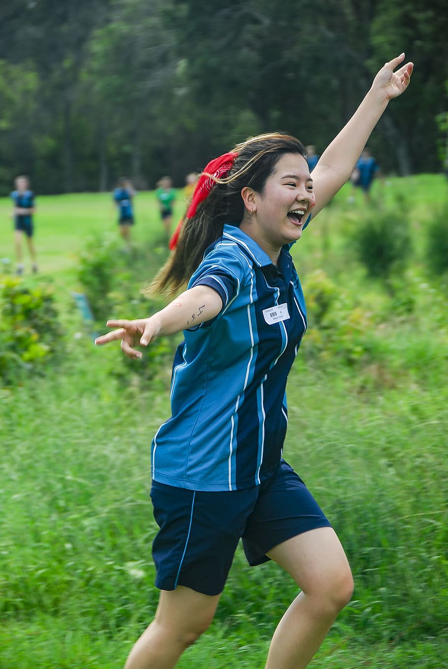Shallow Focus Photo of Woman in Blue Polo Shirt Raising Left Hand HD wallpaper