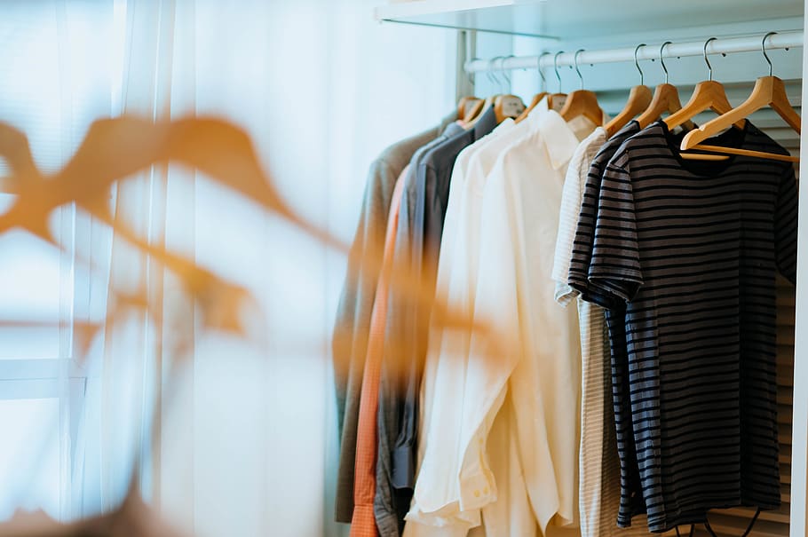 selective focus photography of shirts hanging on rack, apparel