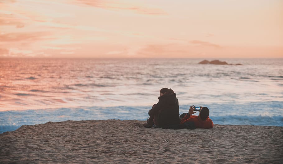 beach, couple, cellular, sunset, sea, sky, water, land, sitting HD wallpaper