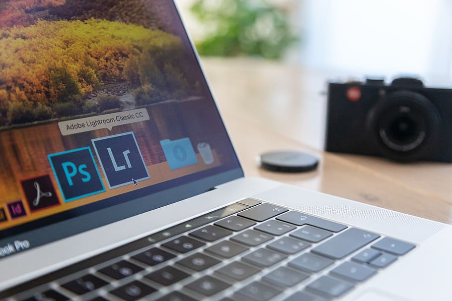 Selective Focus Photography of Macbook Pro Near Film Camera, blurred background HD wallpaper