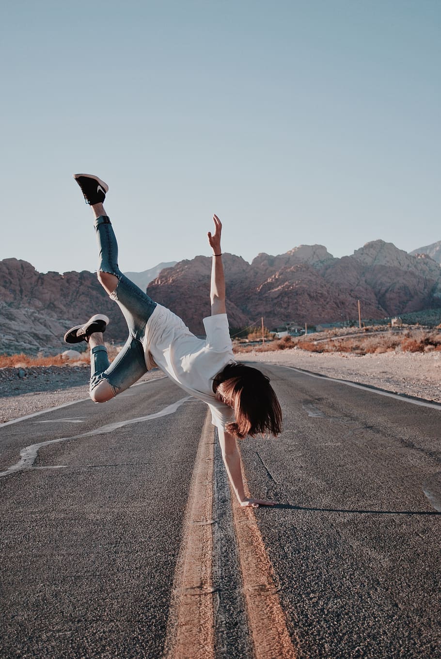 person in skinny jeans doing handstand on road, asphalt, tarmac, HD wallpaper