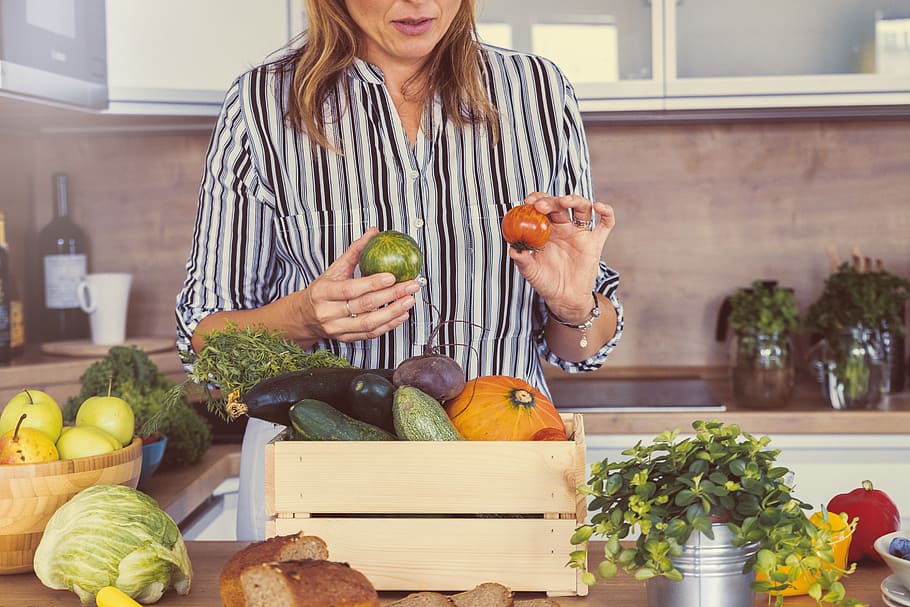 Woman with a pile of fresh vegetables in the kitchen, food and drink HD wallpaper