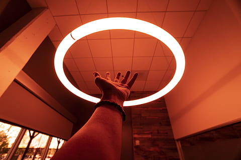 person reaching round turned-on fluorescent lamp in room, light HD wallpaper