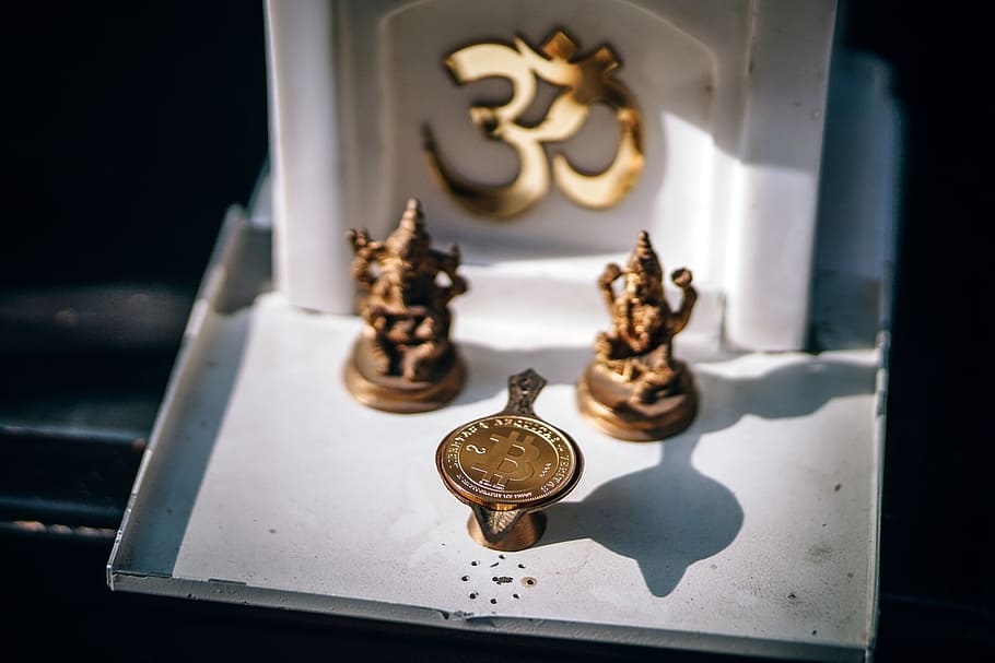 Bitcoin Cryptocurrency placed along with the Indian Buddhist Miniature Sculptures. Holy Physical BTC. HD wallpaper