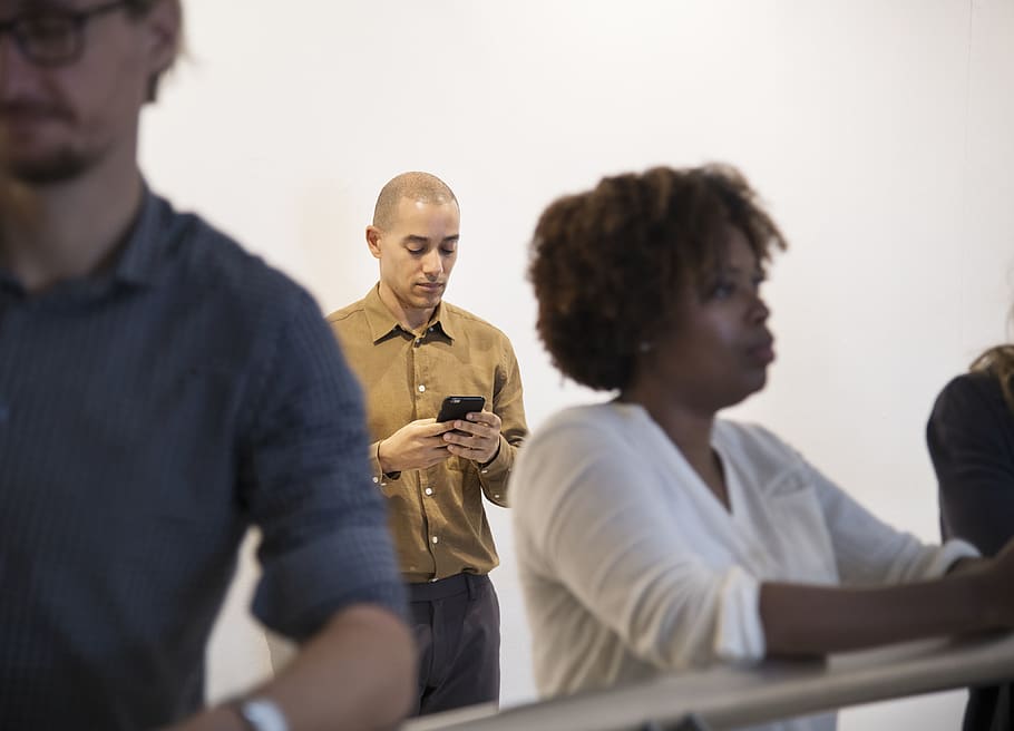 Man Holding Smartphone, busy, cellphone, device, woman, men, group of people HD wallpaper