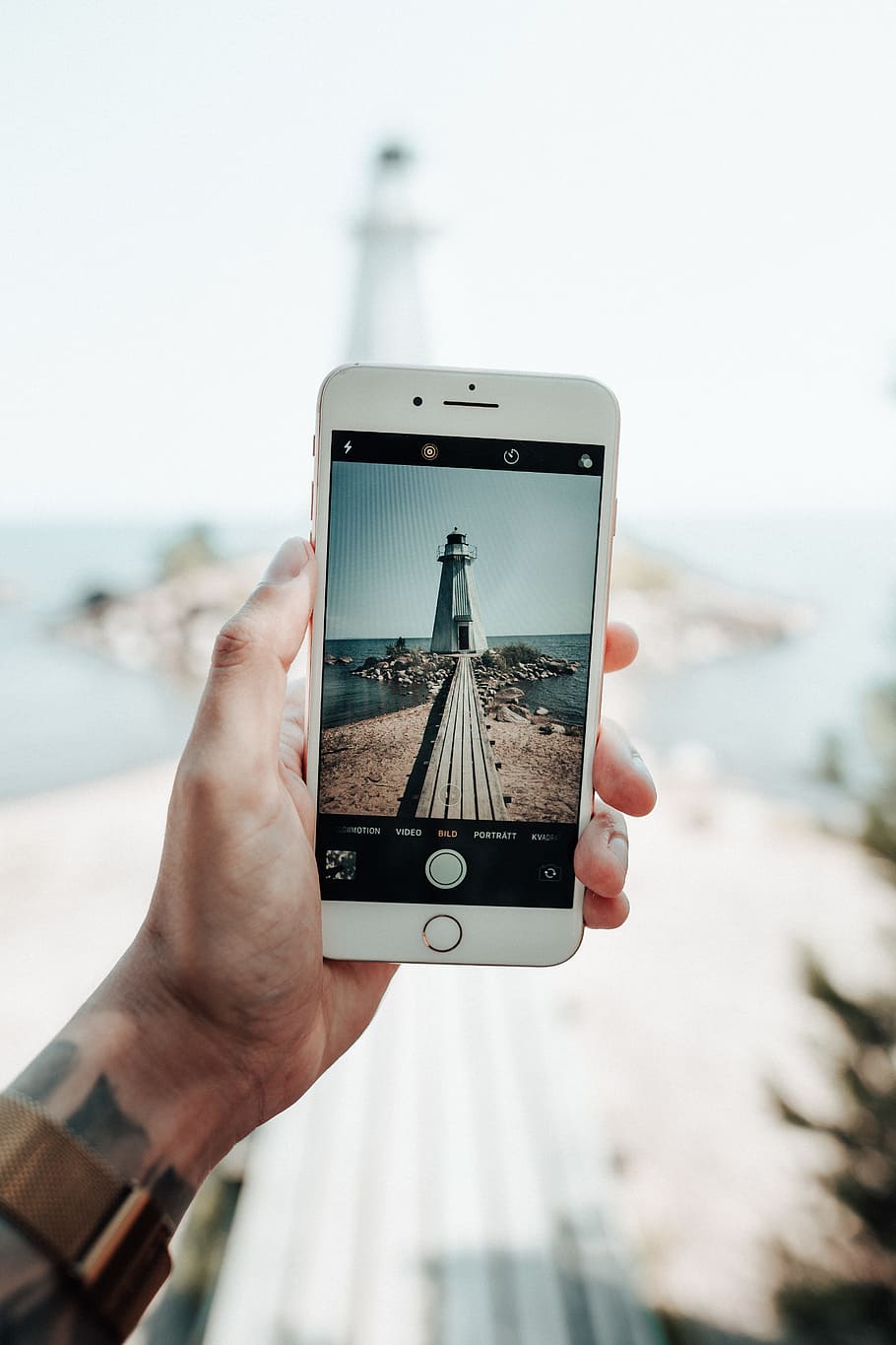 white lighthouse through phone, device, screen, iphone, taking photo HD wallpaper