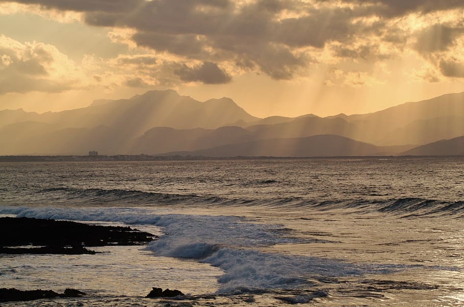 Silhoutte of Mountain Distant from Body of Water, beach, clouds HD wallpaper