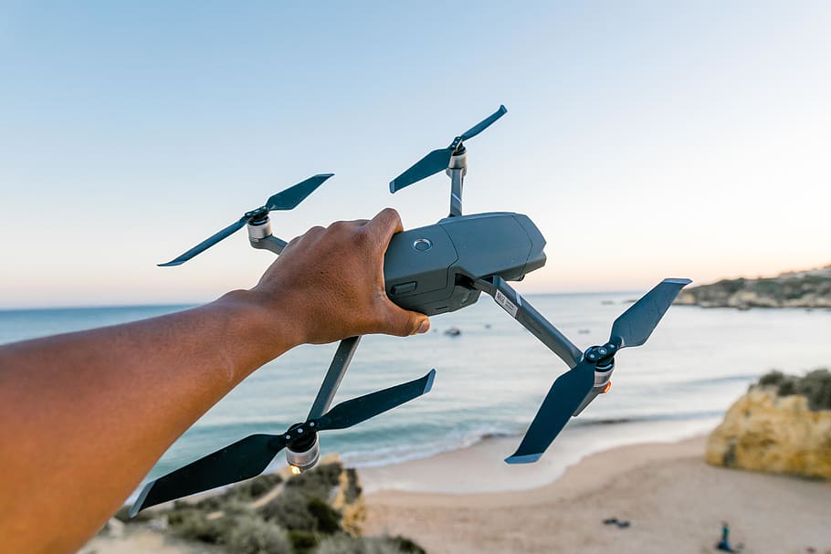 Person Holding Gray and Black Quadcopter Drone, beach, camera