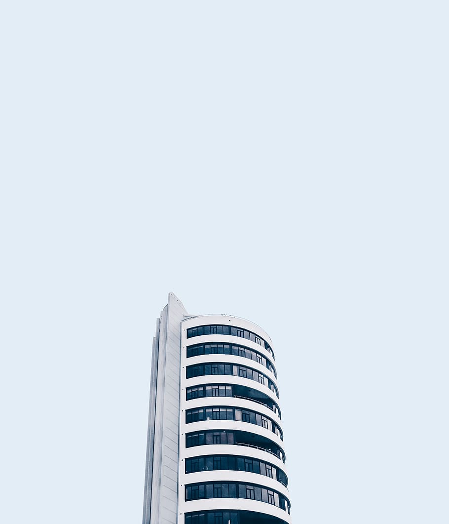 low angle photo of white high rise building under white sky at daytime HD wallpaper