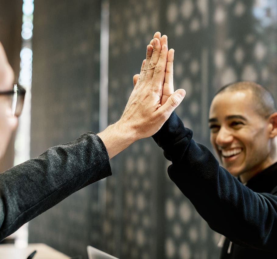 Two Men Doing a High-five, blurred background, cheerful, colleague
