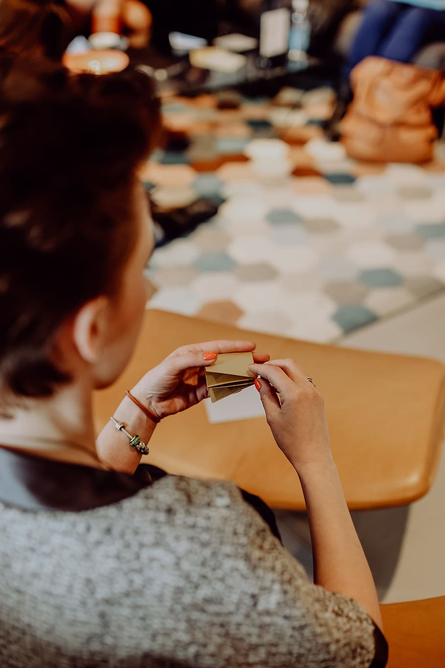 Women folding sheet of paper while making origami, creative, workshop HD wallpaper