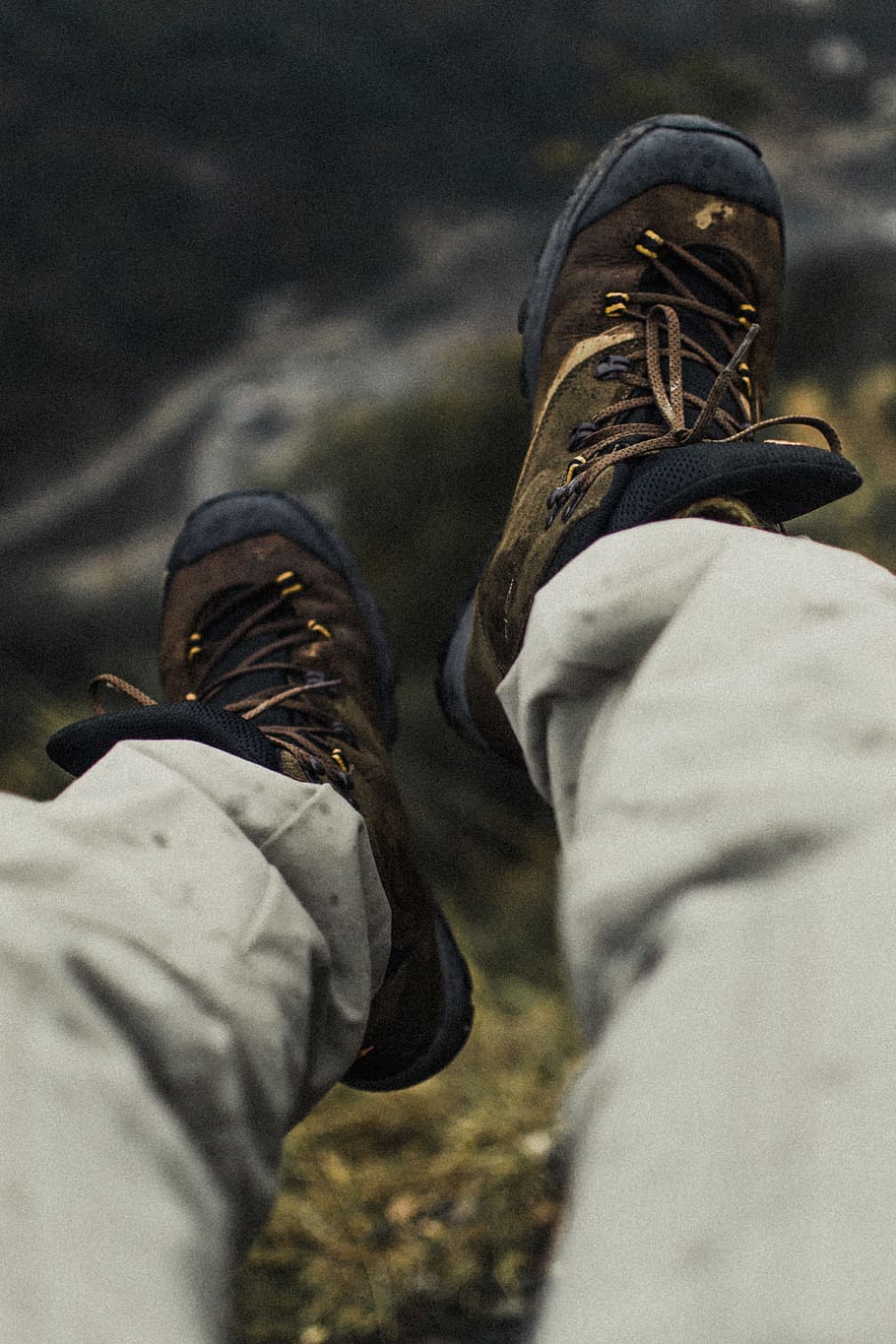 selective focus photography of person wearing hiking shoes, boot