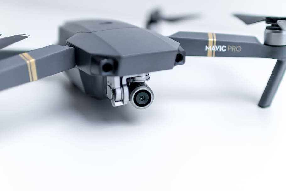 Modern drone on white desk in the office ready to filming, indoors HD wallpaper