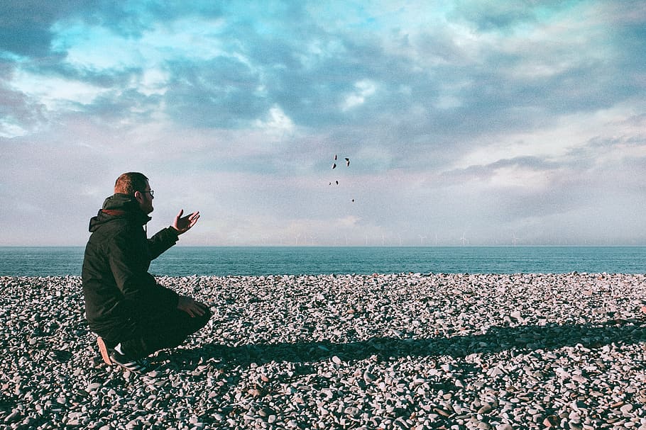 Man Throwing Stones, clouds, daylight, gesture, guy, hoodie, horizon HD wallpaper