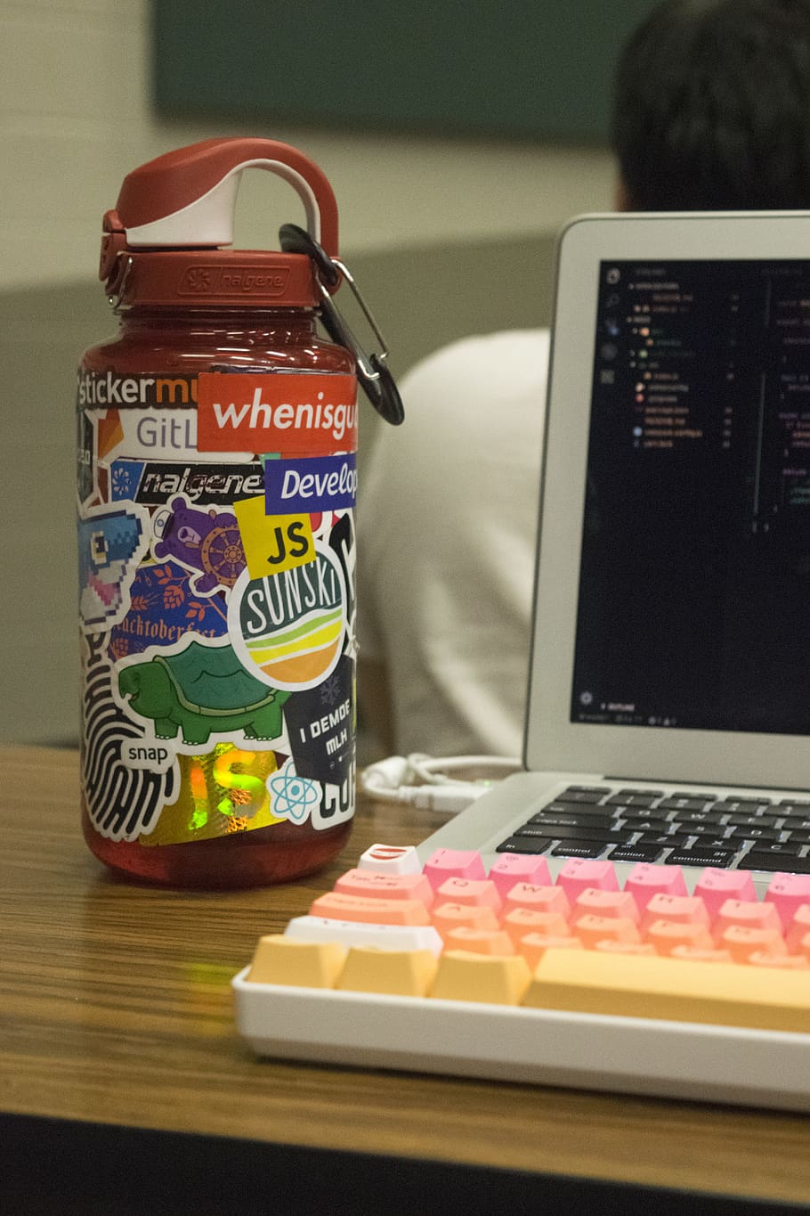 orange plastic container beside turned-on MacBook Pro, computer HD wallpaper