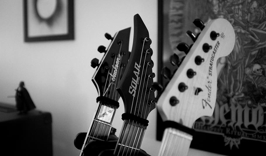 greyscale photography of guitar, electrical device, switch, game