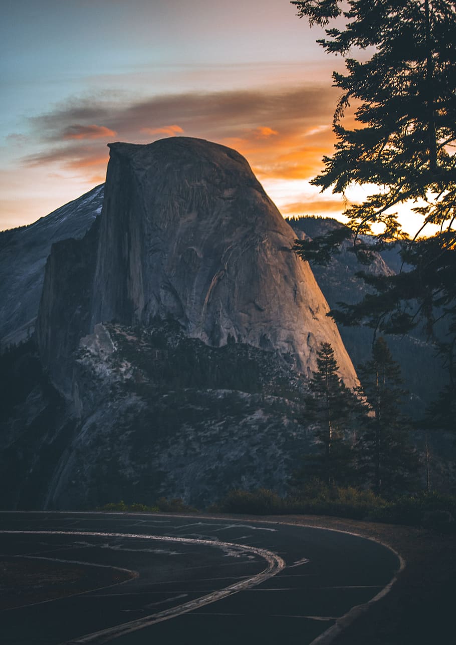 concrete road near hill with trees, mountain, dome, sunset, landscape HD wallpaper