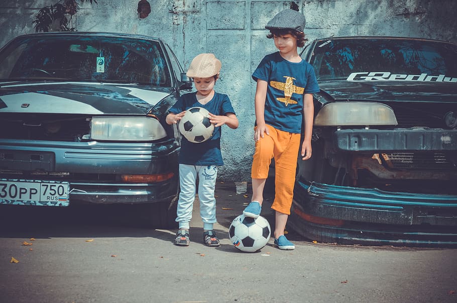 Two Boys Playing Soccer Ball Beside Cars, ballgame, balls, children, HD wallpaper