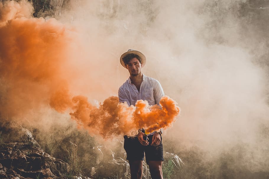 Man Holding Smoke Bomb, orange, person, smoke - physical structure