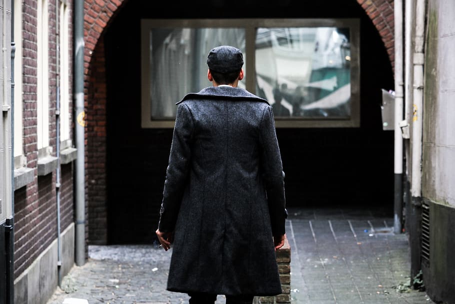 Man Looking at the Window, back, brickwalls, building, coat, daytime HD wallpaper