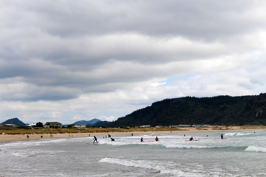 People on Beach Under Grey Cloudy Sky, active, clouds, ocean HD wallpaper
