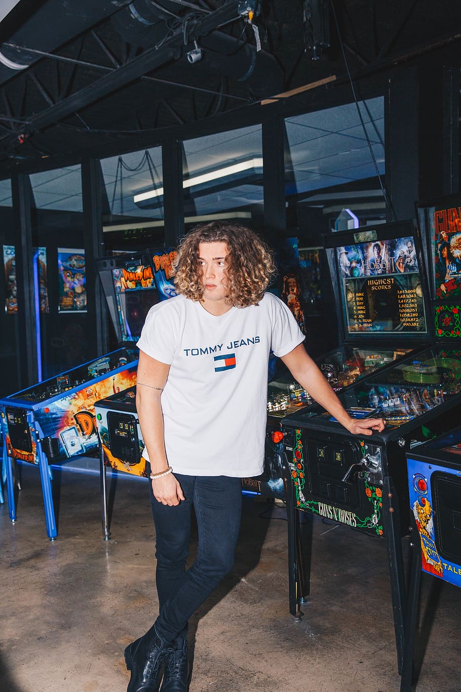 man standing leaning on arcade game, one person, real people HD wallpaper