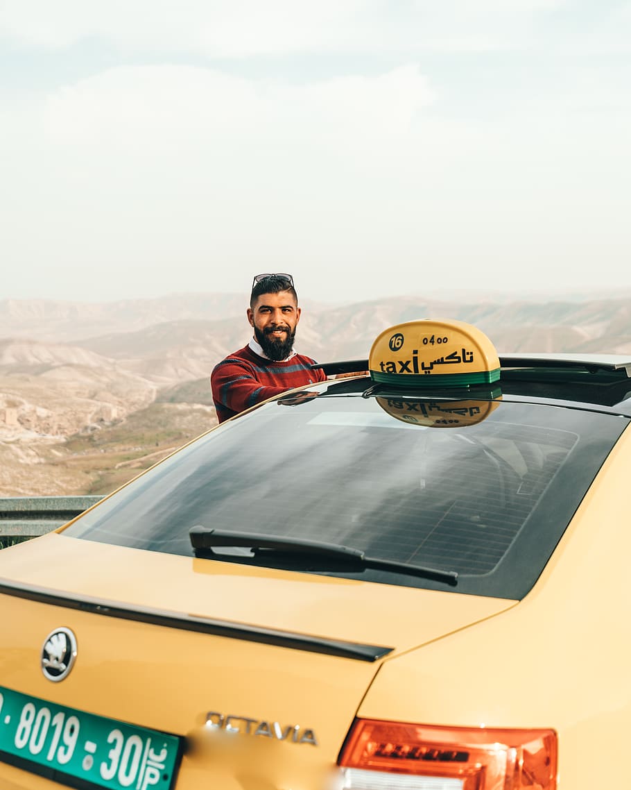 man standing beside yellow Skoda Octavia vehicle, car, automobile