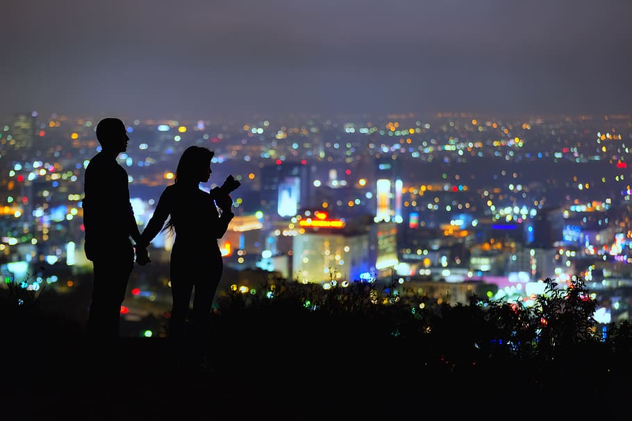 couple standing on hill overlooking city at night, human, person, HD wallpaper