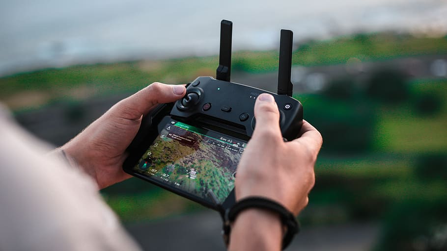person holding smartphone with Bluetooth controller, human hand HD wallpaper