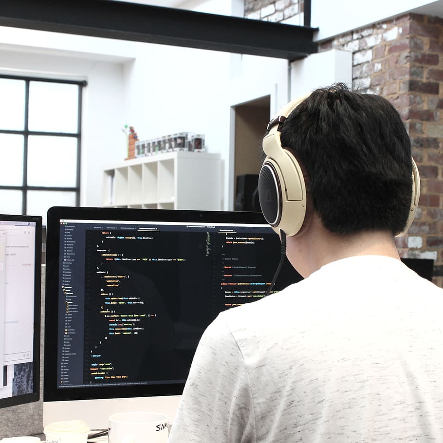 man wearing headphones while using computer, person, human, people