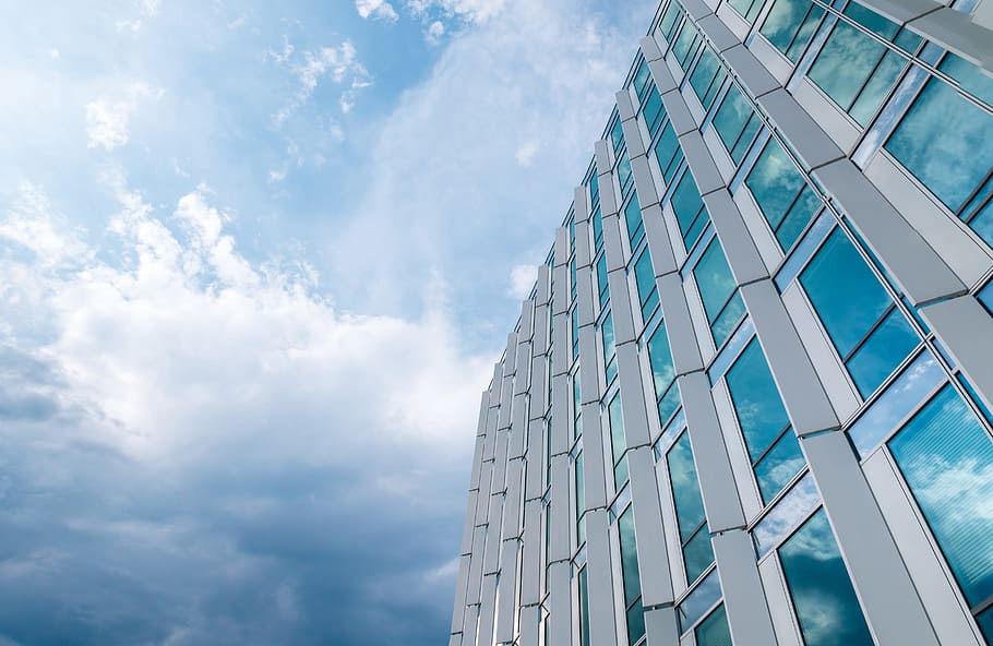 Amazing office building with windows. Blue sky with clouds after rain HD wallpaper