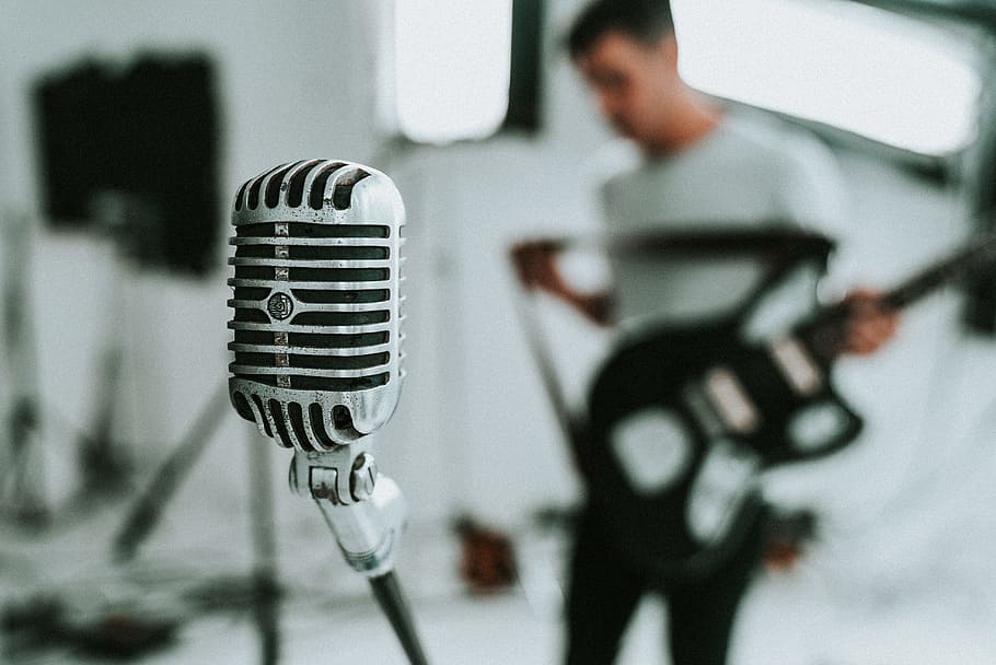 guitarist holding black guitar, microphone, person, singer, audio HD wallpaper