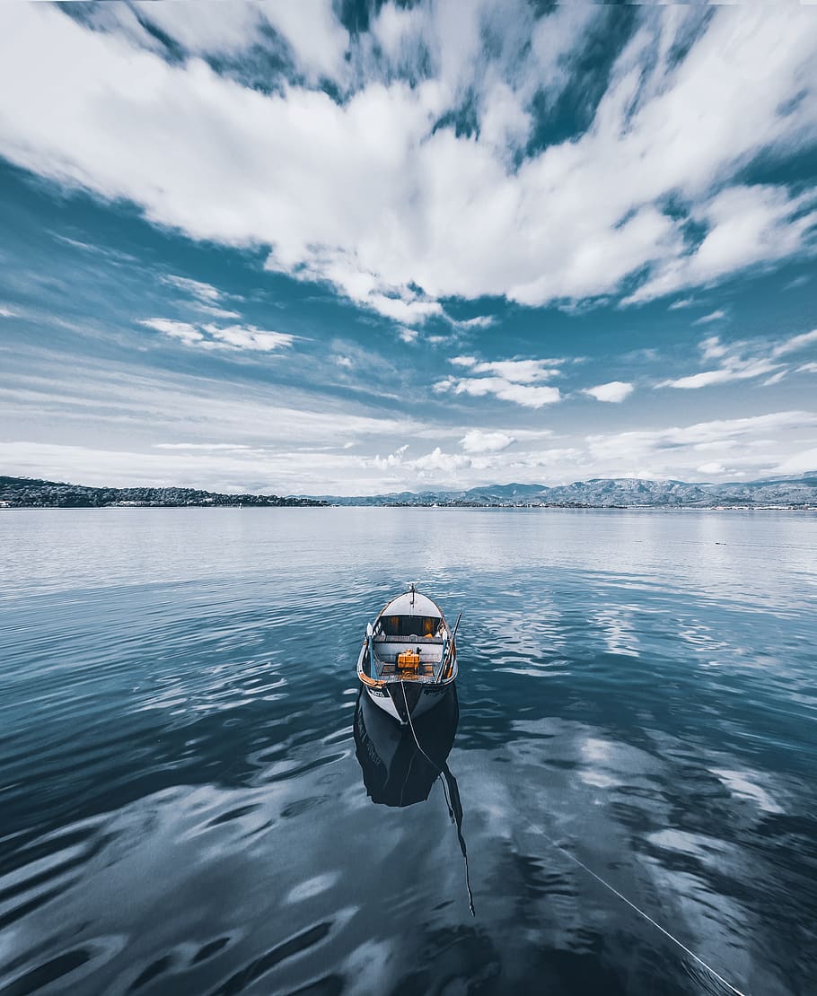 Photo of Boat Under Cloudy Sky, canoe, clouds, environment, fishing boat