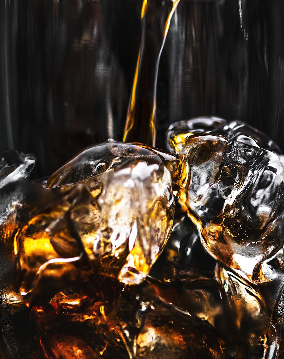 Liquor Pouring on Glass Full of Ice, beverage, black background