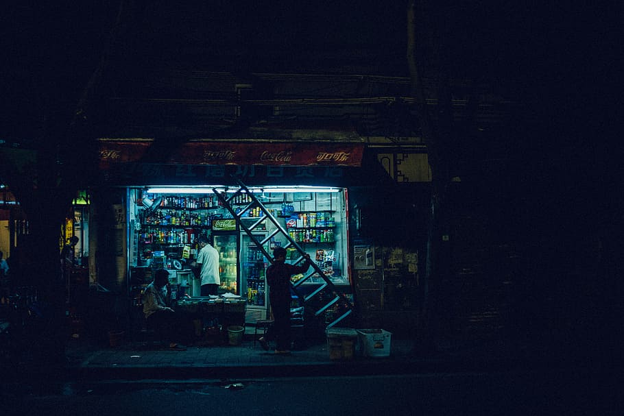 man carrying ladder in front open store at night, street, indoors HD wallpaper