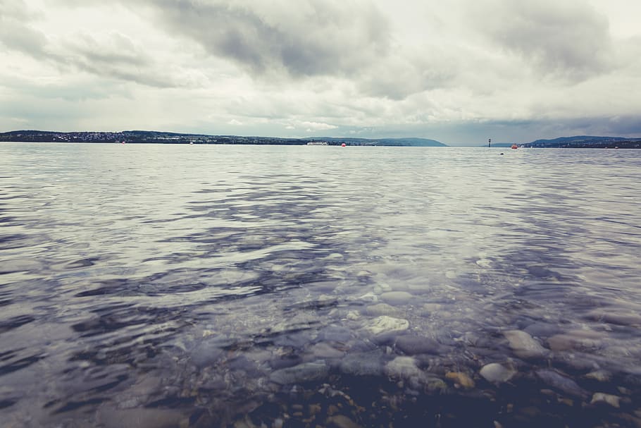 Body of Water Under Gray Sky, beach, clear water, clouds, dawn HD wallpaper