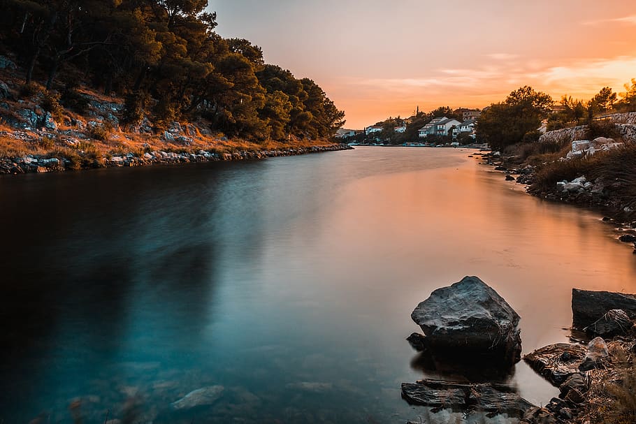 Calm Body of Water Near Land, buildings, clouds, dawn, environment HD wallpaper