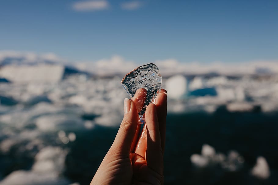 person holding ice, human hand, one person, human body part, focus on foreground HD wallpaper